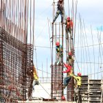 people working on building during daytime